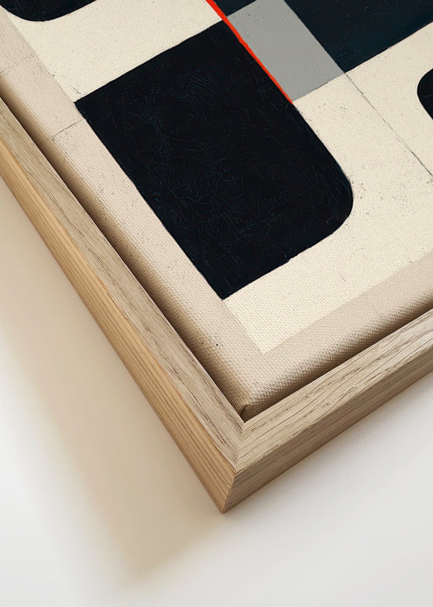 Cuadro geométrico con bloques negros y acento rojo – Canvas detail