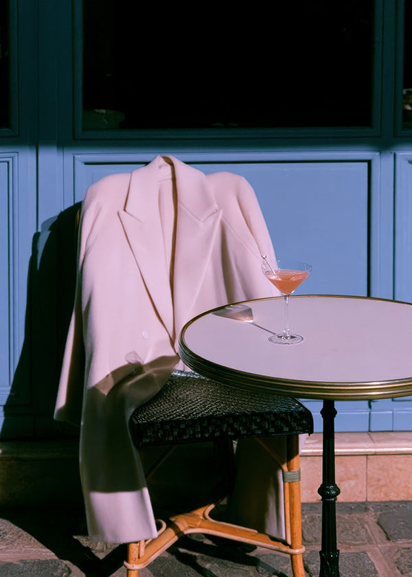 Fotografía chaqueta rosa y cóctel en terraza